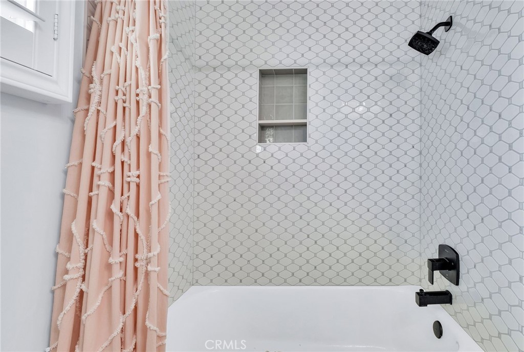 3638 North Studebaker Road Long Beach, CA 90808 - Photo 27 of 55 a bathroom with a bathtub and a shower