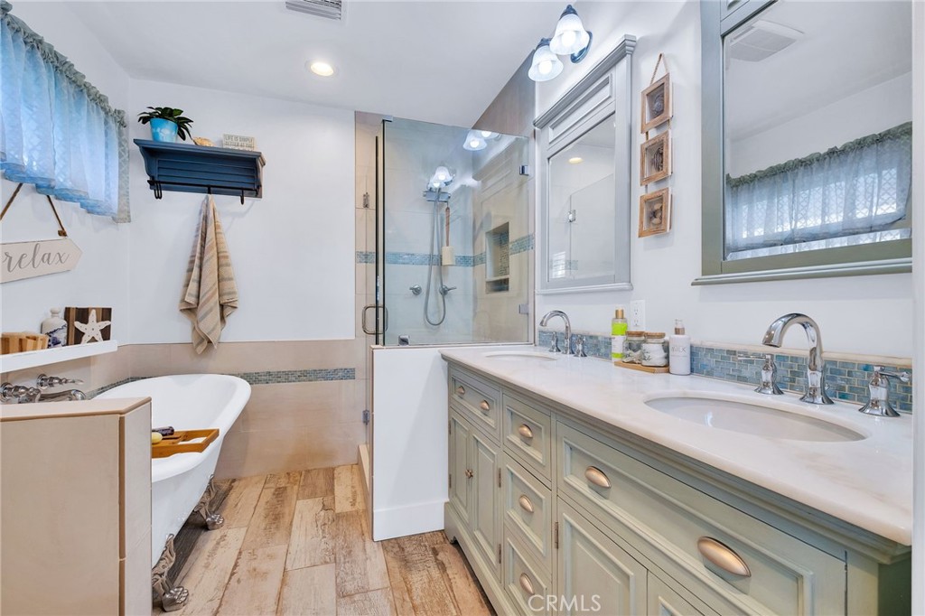 3638 North Studebaker Road Long Beach, CA 90808 - Photo 34 of 55 a spacious bathroom with a granite countertop sink a mirror a vanity and shower