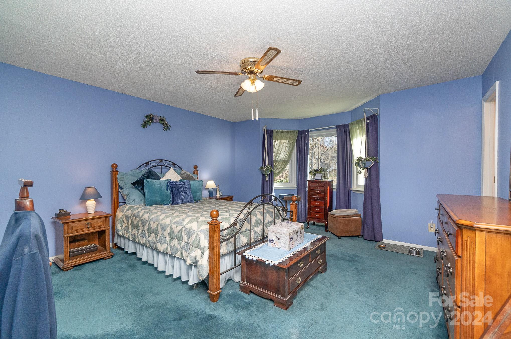 21014 Pine Ridge Drive Cornelius, NC 28031 - Photo 12 of 33 a bedroom with a bed and a chandelier