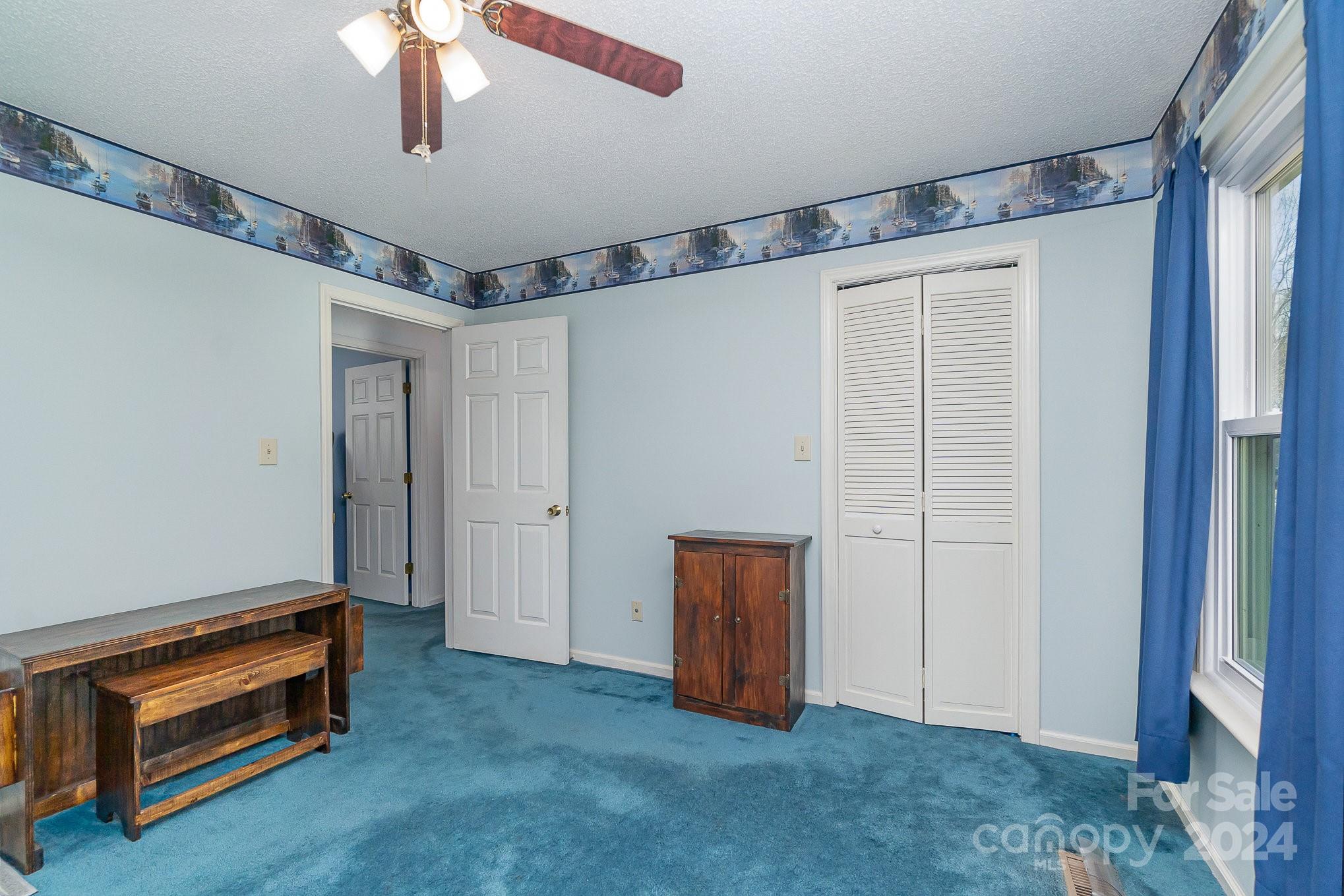 21014 Pine Ridge Drive Cornelius, NC 28031 - Photo 17 of 33 a view of an empty room with a ceiling fan