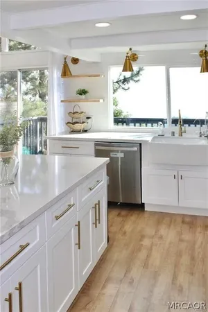 a kitchen with a sink cabinets and a window