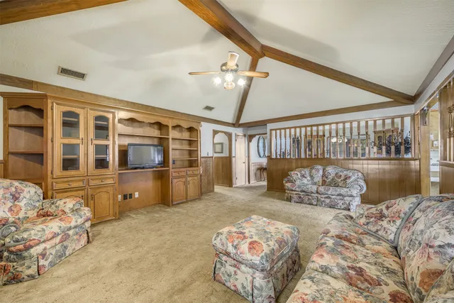 a bedroom with furniture and a large window