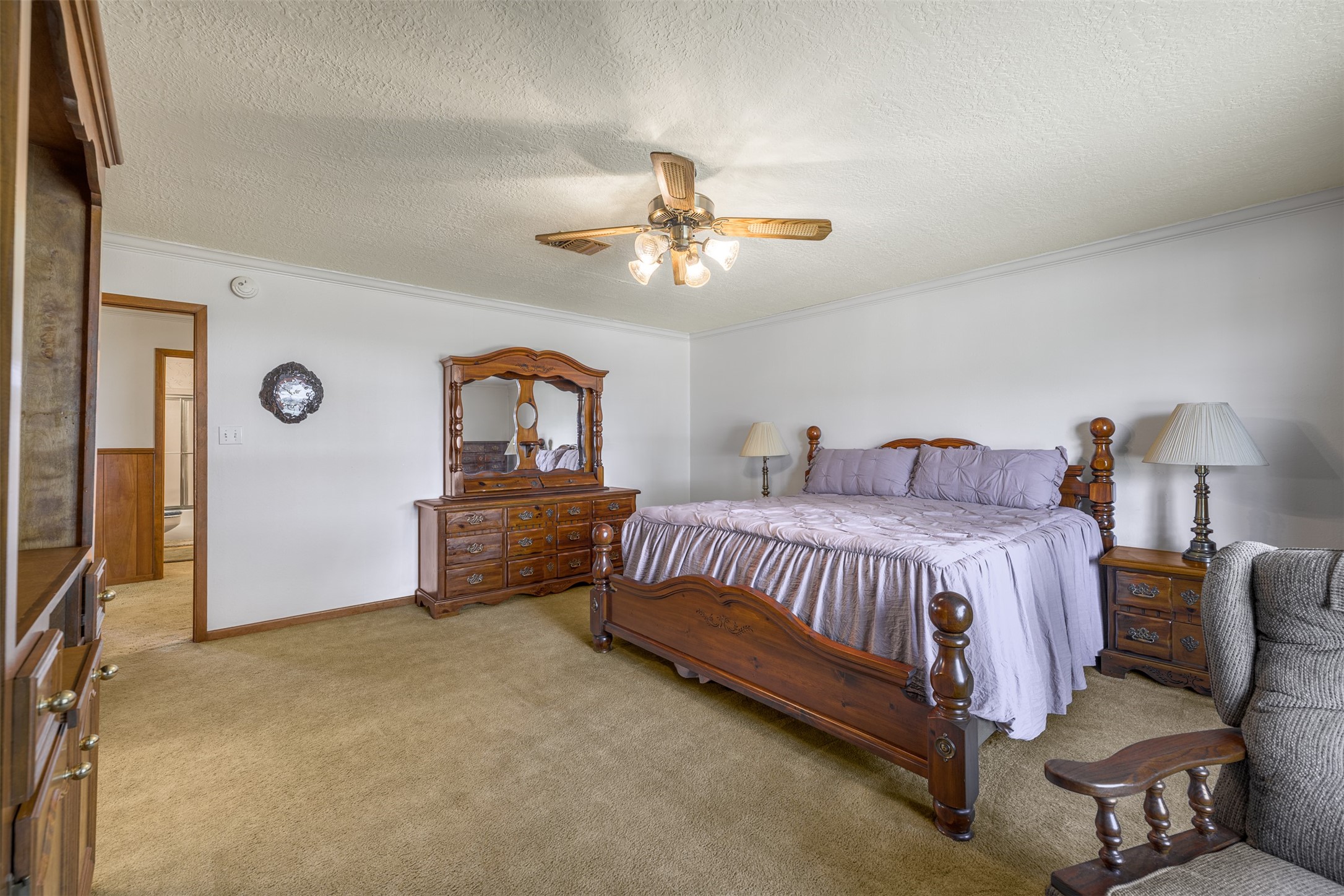 6700 FM 332 Road Brenham, TX 77833 - Photo 19 of 36 a spacious bedroom with a bed and a chandelier
