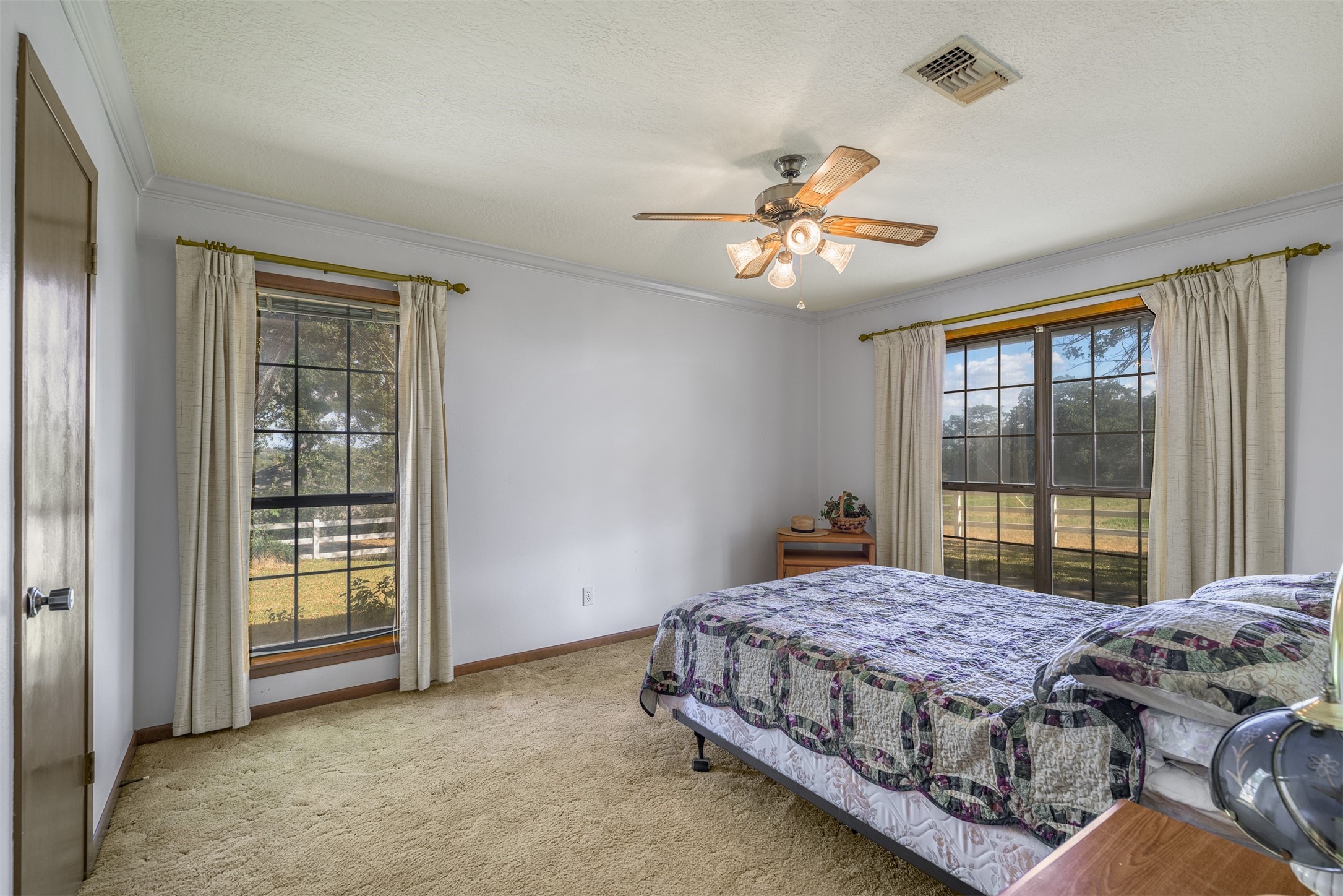 6700 FM 332 Road Brenham, TX 77833 - Photo 21 of 36 a bedroom with a large bed and a chandelier