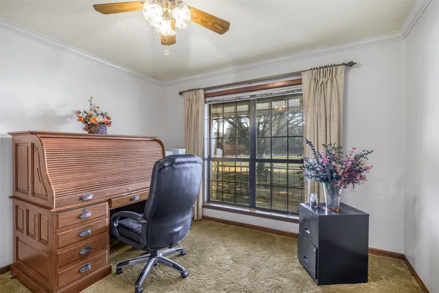 a view of a livingroom with furniture and a window