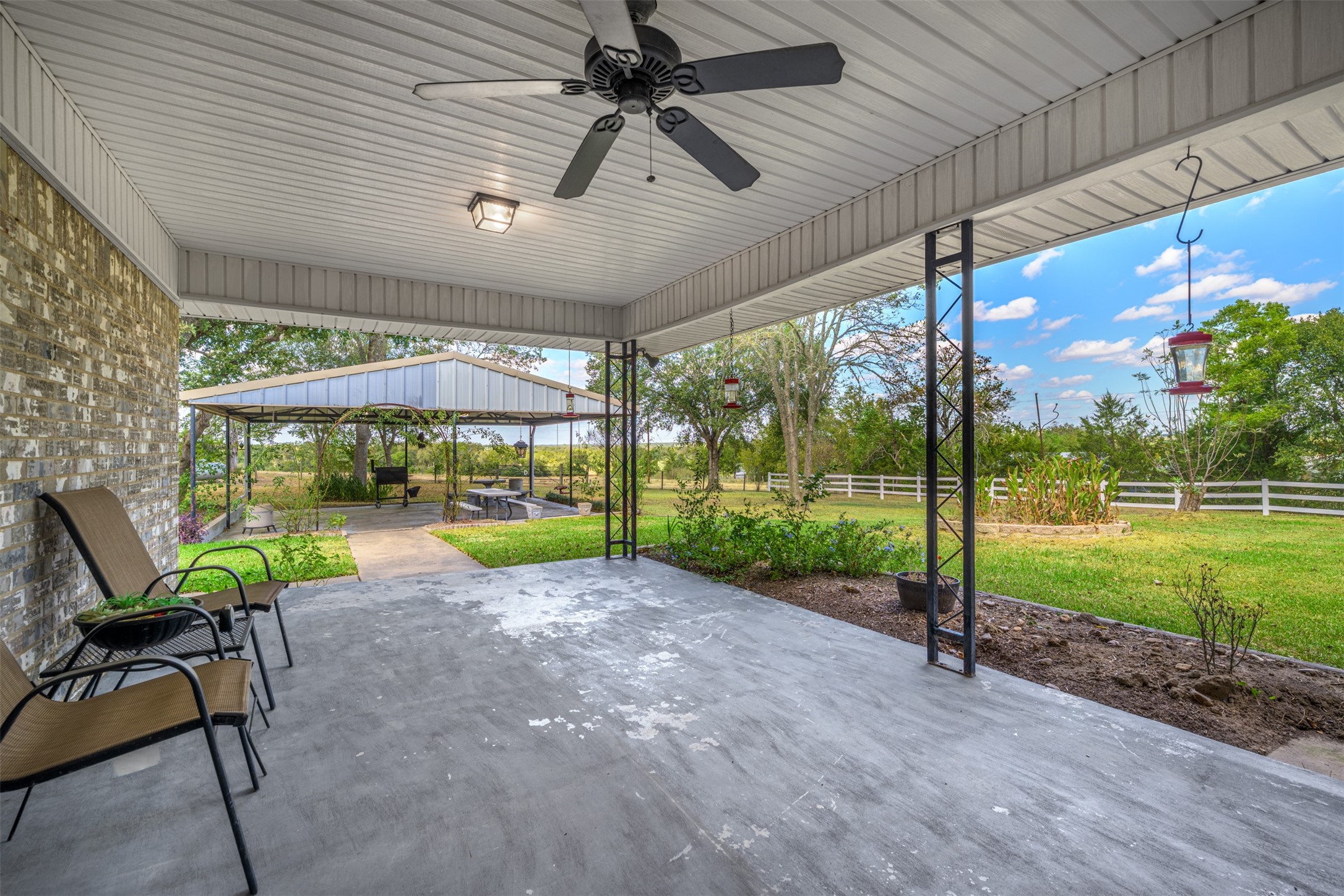 6700 FM 332 Road Brenham, TX 77833 - Photo 25 of 36 a view of a patio with a table chairs and a backyard