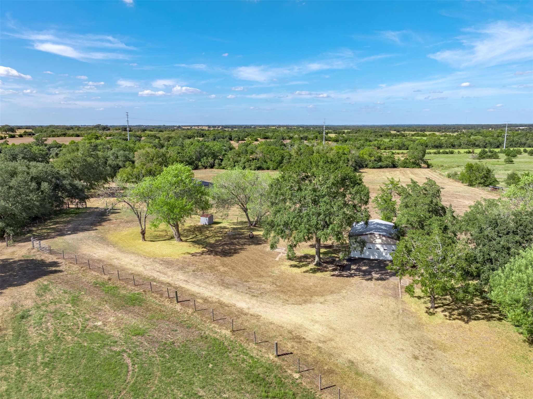 6700 FM 332 Road Brenham, TX 77833 - Photo 31 of 36 a view of a lake with a building in the back