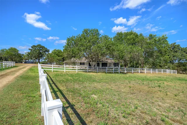 a view of a swimming pool with a yard