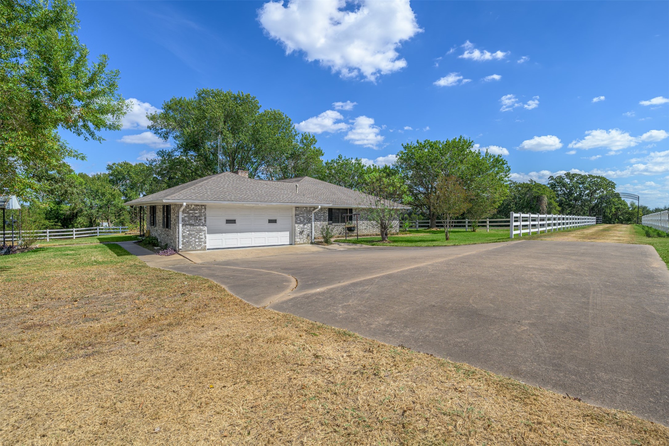 6700 FM 332 Road Brenham, TX 77833 - Photo 10 of 36 a front view of a house with a yard and garage