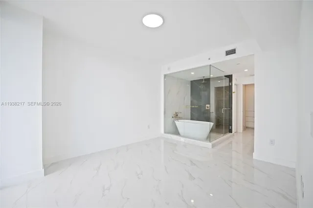 a bathroom with a shower and a sink