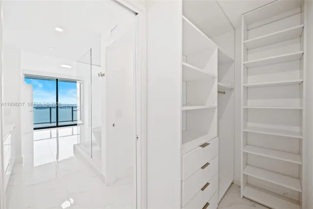 an empty room with large mirror