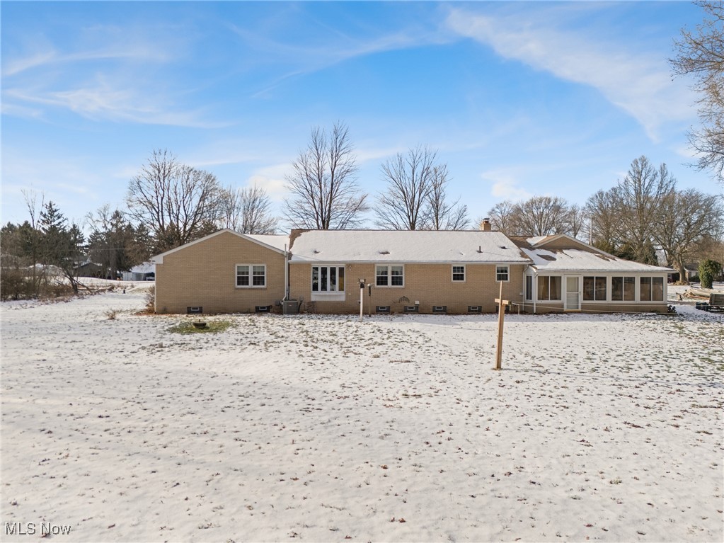 14965 Seacrist Road Salem, OH 44460 - Photo 26 of 43 Snow covered property with a sunroom, a chimney, and brick siding