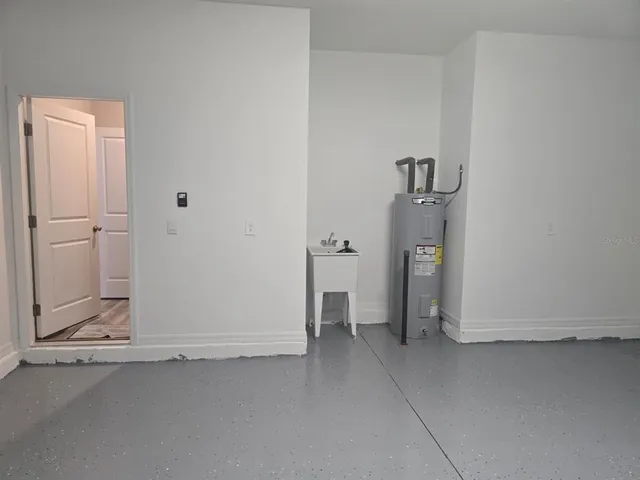 an empty room with an entrance and wooden door