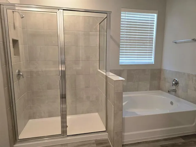 an empty room with closet and a chandelier fan