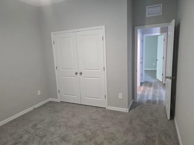 an empty room with closet area