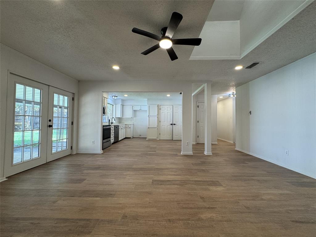6645 Starnes Road Watauga, TX 76148 - Photo 3 of 18 Spacious room featuring wood-finish flooring, recessed lighting, and a ceiling fan