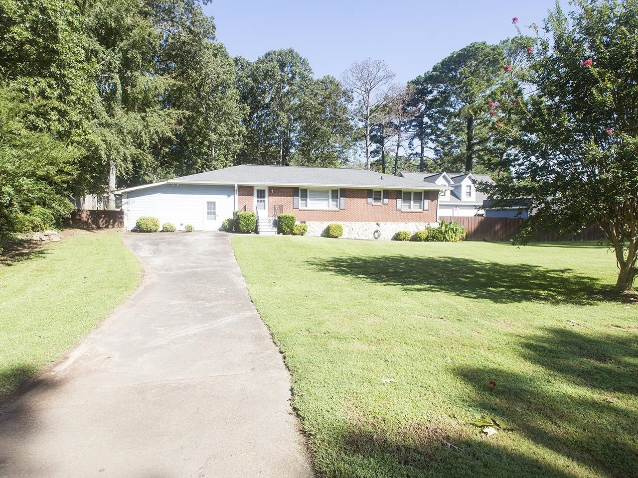 1087 East Atlanta Road Stockbridge, GA 30281 - Photo 1 of 1 a front view of a house with a yard and garage