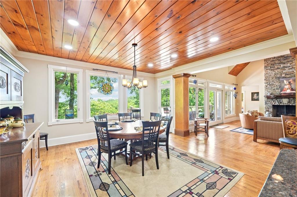 44 Sassafras Ridge Big Canoe, GA 30143 - Photo 18 of 107 a dining room with wooden floor and large windows