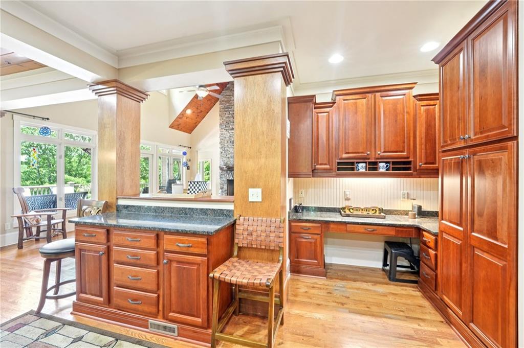 44 Sassafras Ridge Big Canoe, GA 30143 - Photo 23 of 107 a kitchen with stainless steel appliances granite countertop a refrigerator and wooden cabinets