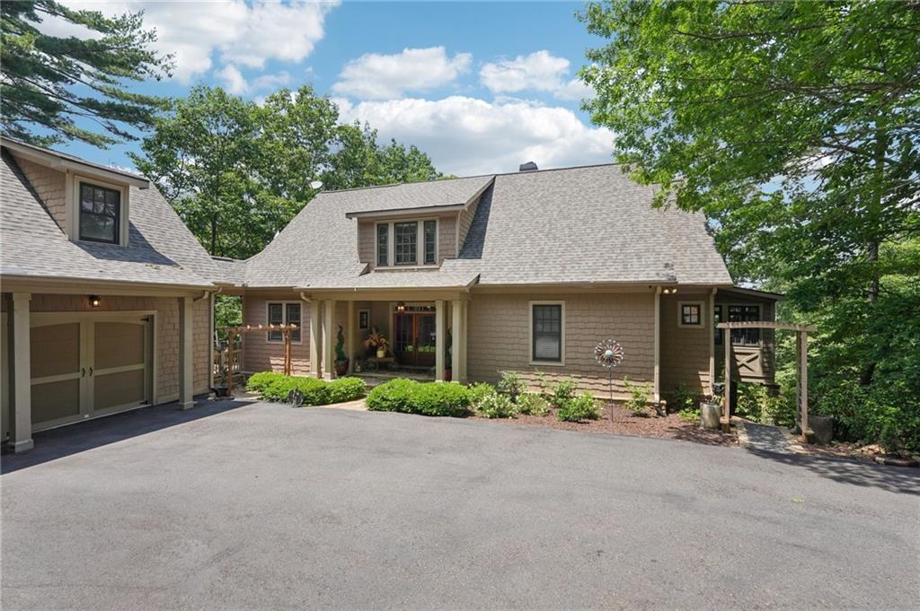 44 Sassafras Ridge Big Canoe, GA 30143 - Photo 5 of 107 a front view of a house with a garden