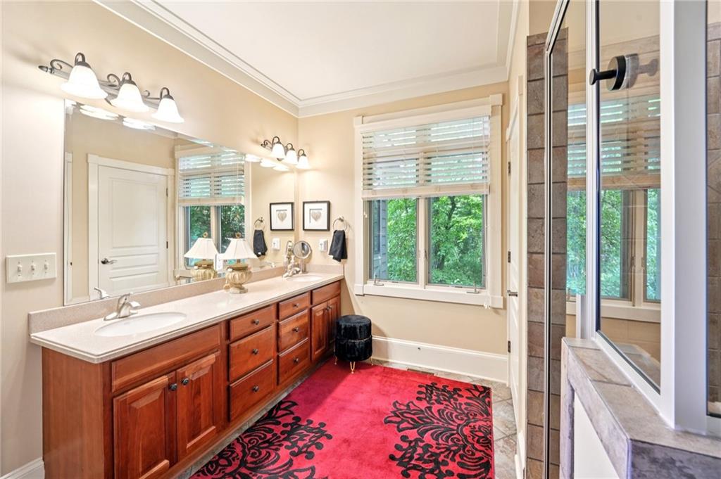 44 Sassafras Ridge Big Canoe, GA 30143 - Photo 57 of 107 a spacious bathroom with a double vanity sink a large mirror and a bathtub next to a window