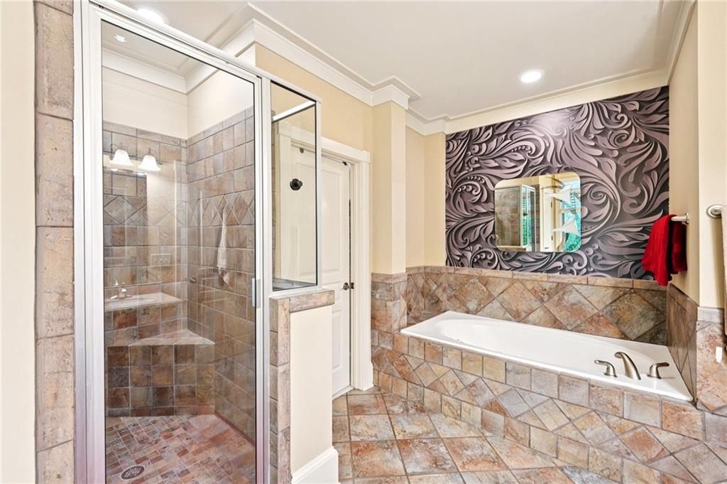 44 Sassafras Ridge Big Canoe, GA 30143 - Photo 58 of 107 a bathroom with a bathtub and a shower