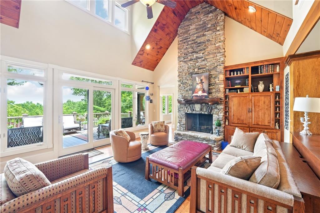 44 Sassafras Ridge Big Canoe, GA 30143 - Photo 9 of 107 a living room with furniture a fireplace and a floor to ceiling window