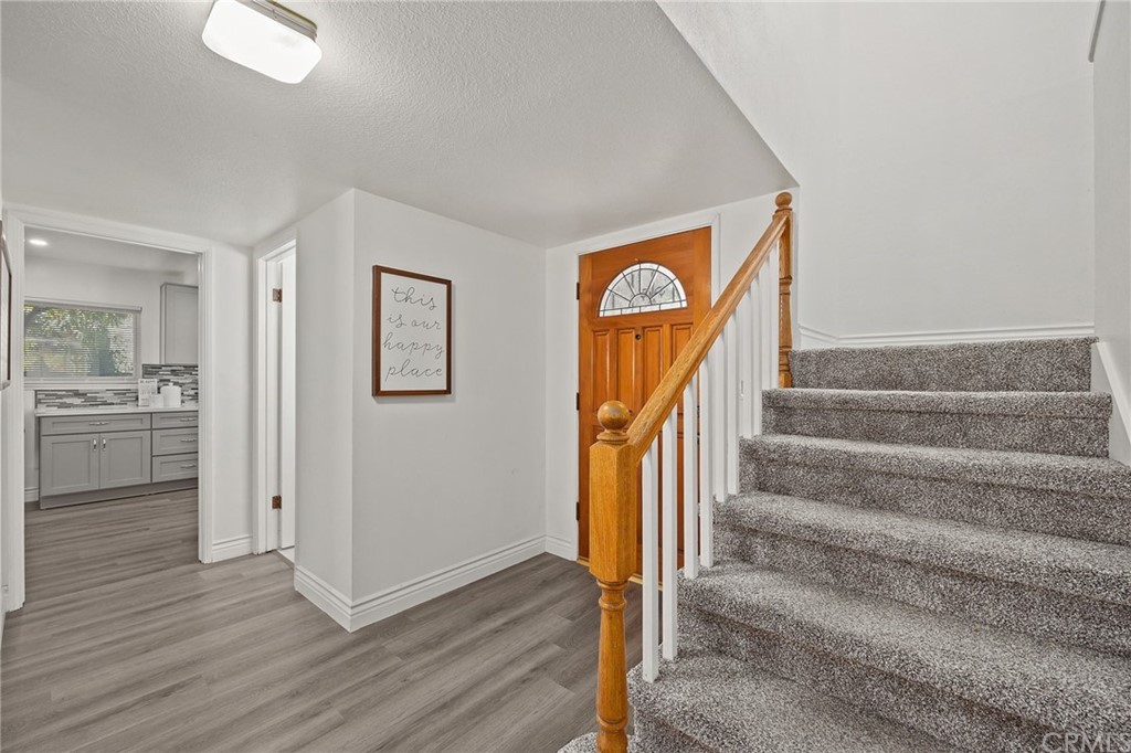 10221 Beaver Circle Cypress, CA 90630 - Photo 12 of 26 a view of a hallway with wooden floor and entryway