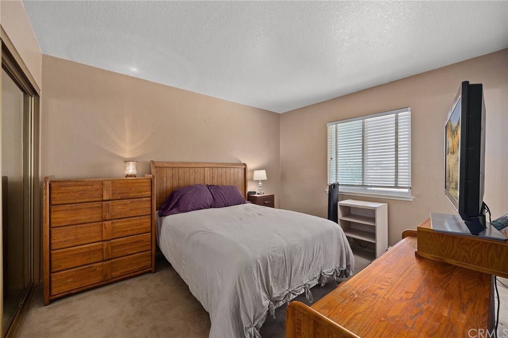 10221 Beaver Circle Cypress, CA 90630 - Photo 17 of 26 a bedroom with two beds and a flat screen television