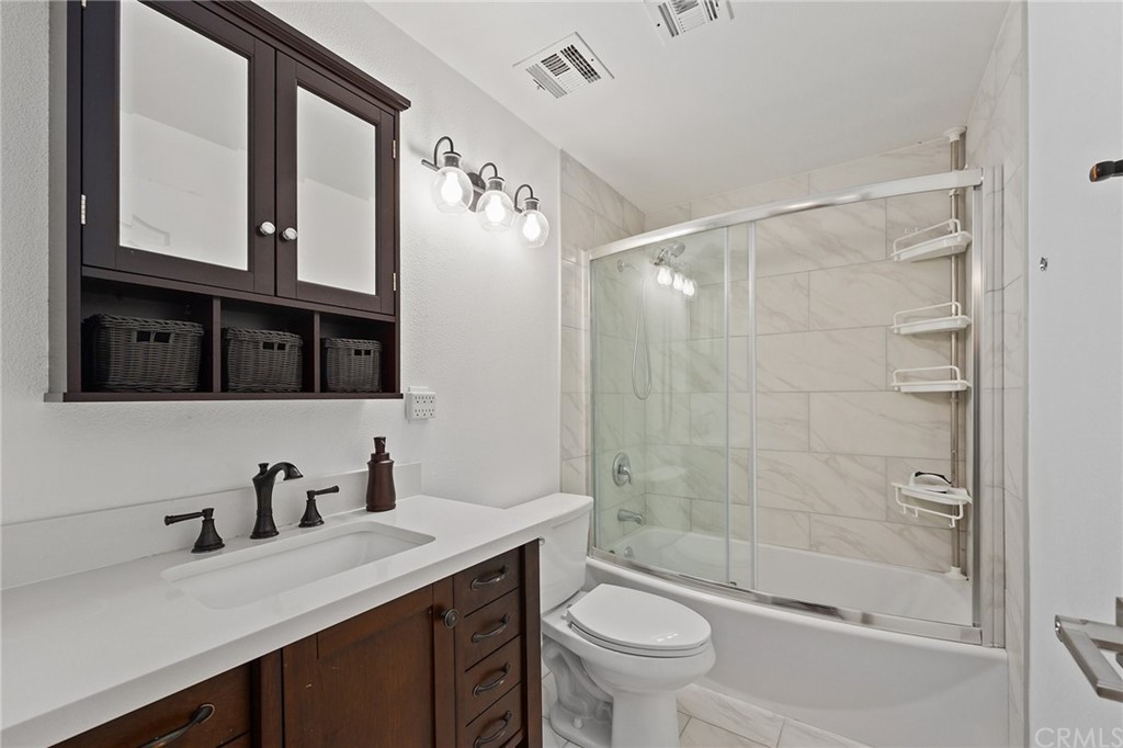 10221 Beaver Circle Cypress, CA 90630 - Photo 19 of 26 a bathroom with a sink a toilet and shower