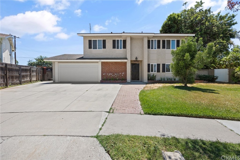 10221 Beaver Circle Cypress, CA 90630 - Photo 2 of 26 a front view of a house with a garden and yard