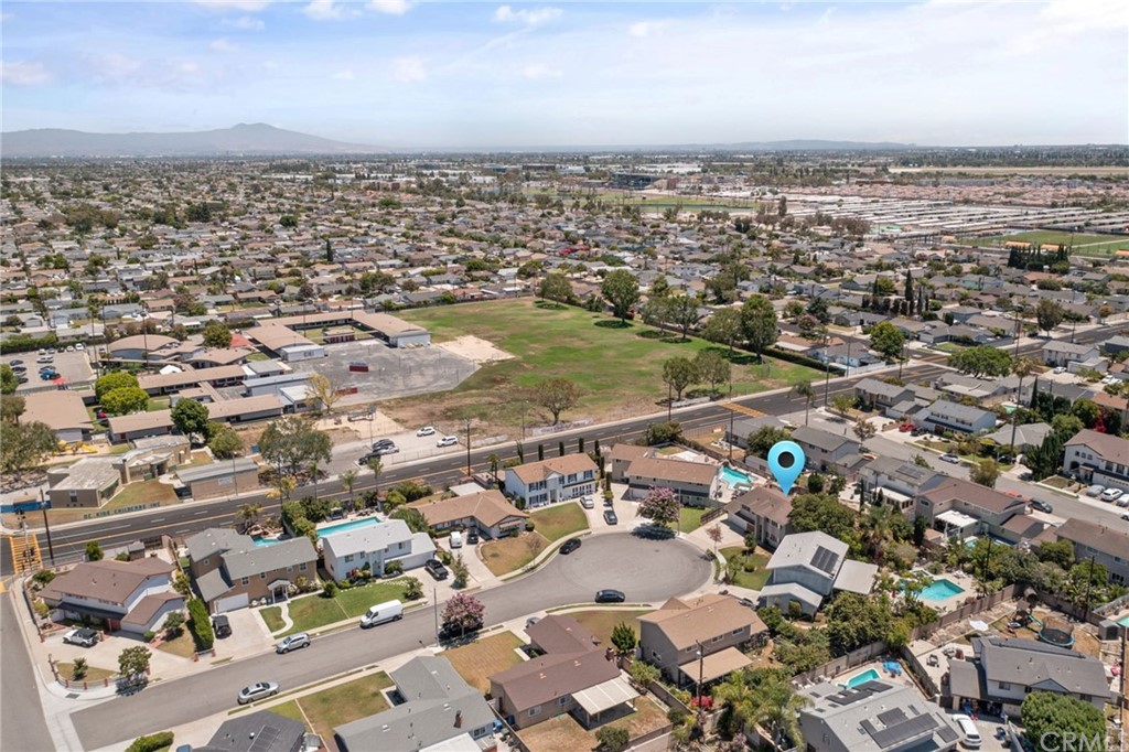 10221 Beaver Circle Cypress, CA 90630 - Photo 24 of 26 an aerial view of a city with ocean