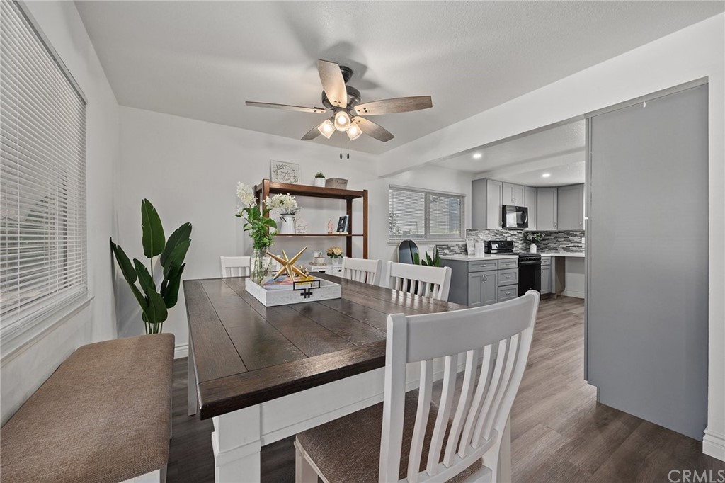 10221 Beaver Circle Cypress, CA 90630 - Photo 7 of 26 a view of a dining room and kitchen with furniture a potted plant and wooden floor