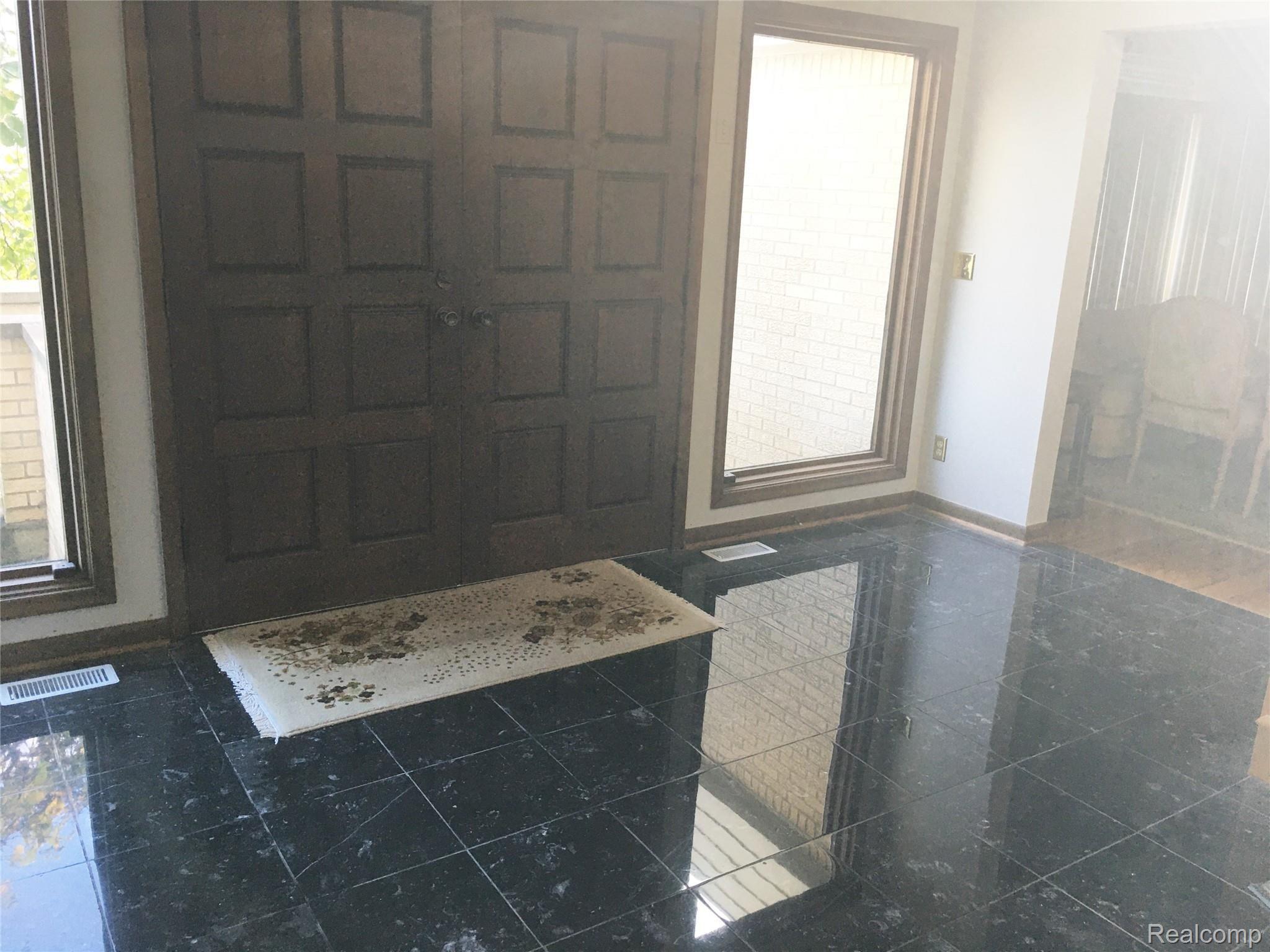 Grand 2 story entrance foyer with Greek Marble floors. 