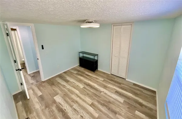 a bedroom with a bed toilet and a window