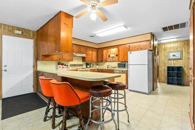 a kitchen with stainless steel appliances a stove sink and cabinets