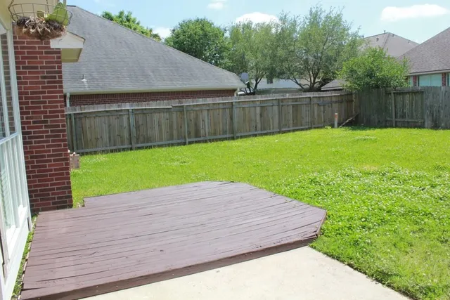 a view of a backyard with a wooden fence