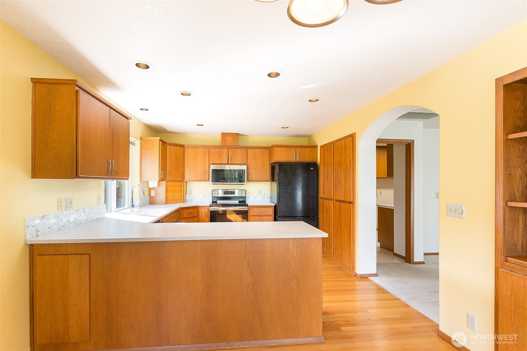 170 Hurricane Ridge Drive Sequim, WA 98382 - Photo 22 of 39 a large kitchen with kitchen island granite countertop a sink and cabinets