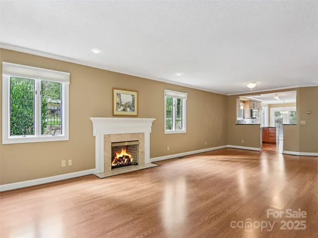 a view of an empty room with window and fire place