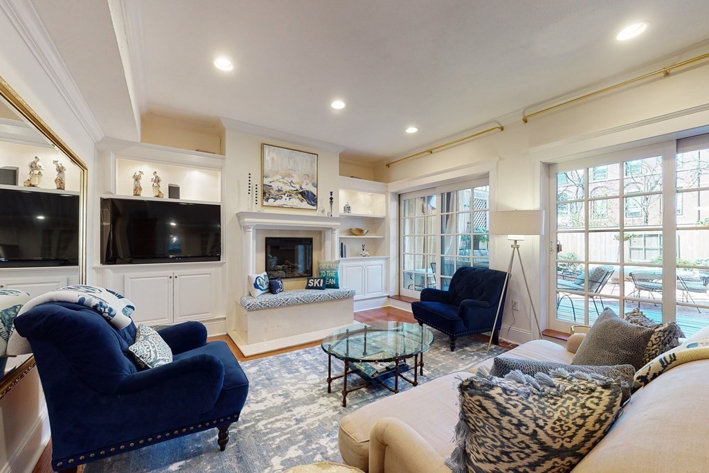 23 Pinckney Street, Unit 1 Boston, MA 02114 - Photo 1 of 17 a living room with furniture a fireplace and a flat screen tv