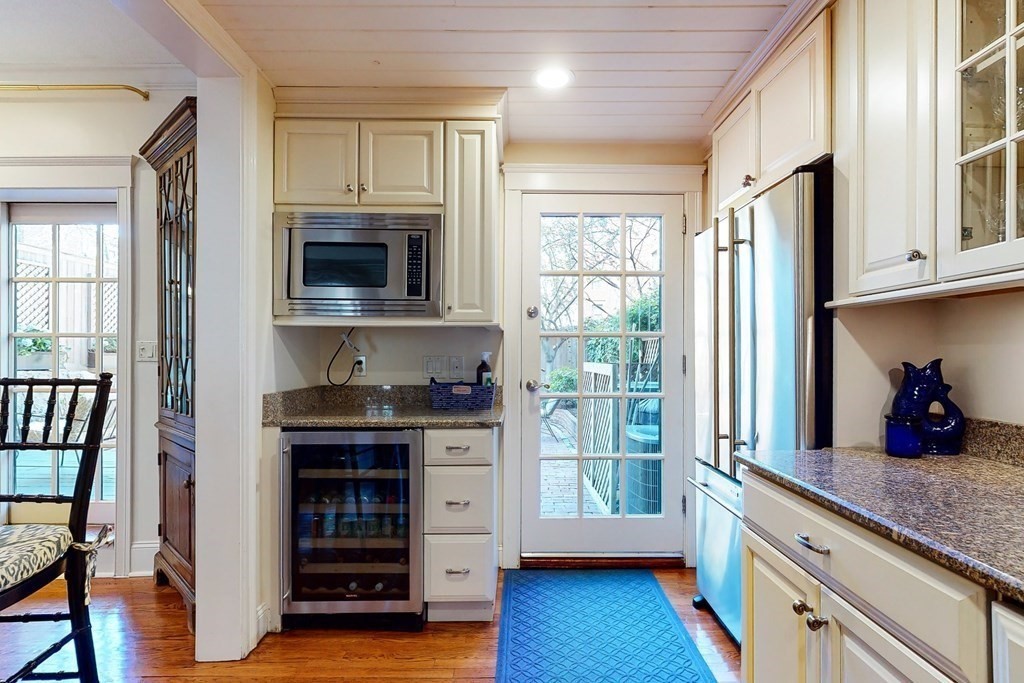 23 Pinckney Street, Unit 1 Boston, MA 02114 - Photo 11 of 17 a kitchen with stainless steel appliances granite countertop a stove and a sink