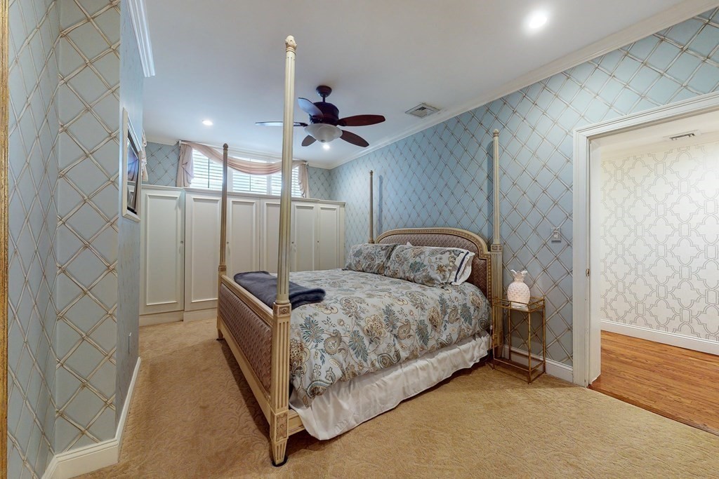 23 Pinckney Street, Unit 1 Boston, MA 02114 - Photo 14 of 17 a bedroom with a bed and ceiling fan