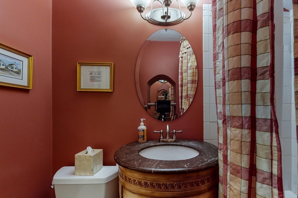 23 Pinckney Street, Unit 1 Boston, MA 02114 - Photo 16 of 17 a bathroom with a toilet a sink and mirror