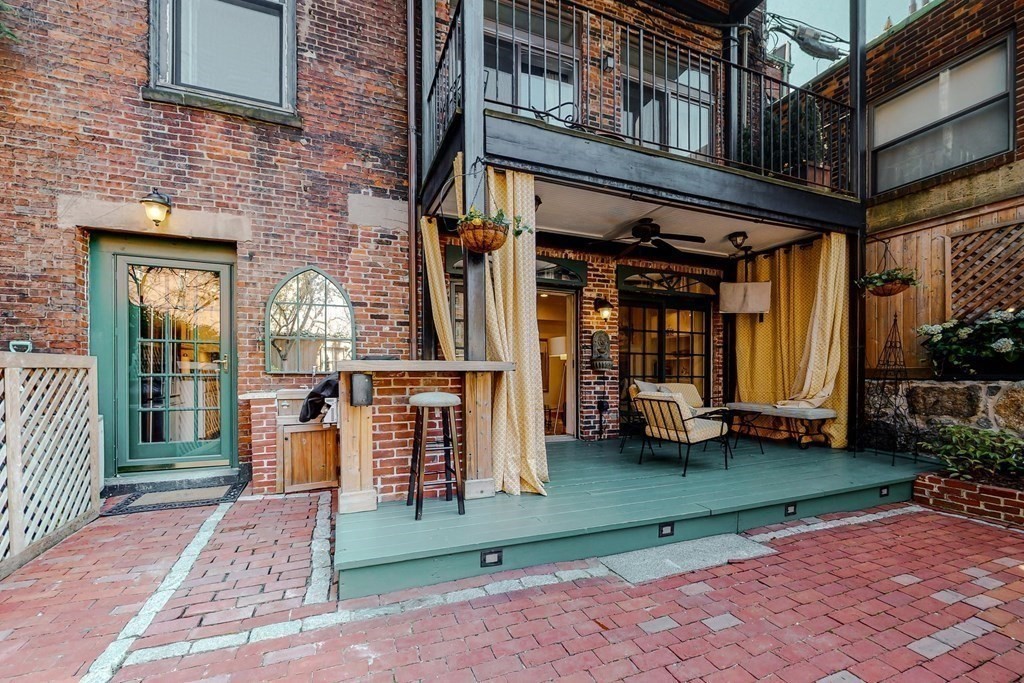 23 Pinckney Street, Unit 1 Boston, MA 02114 - Photo 8 of 17 a view of a brick building with a yard in front of the house