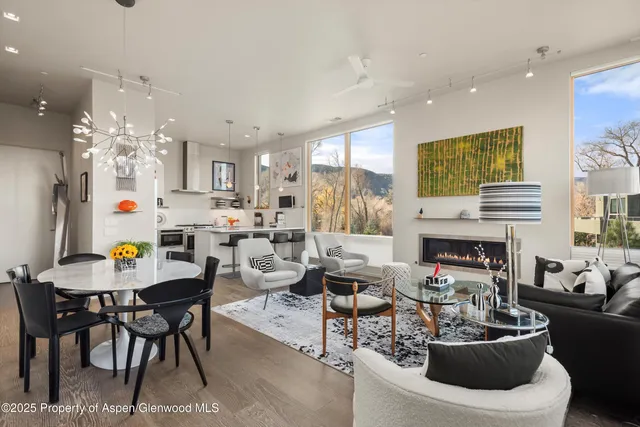 a living room with fireplace furniture and a chandelier