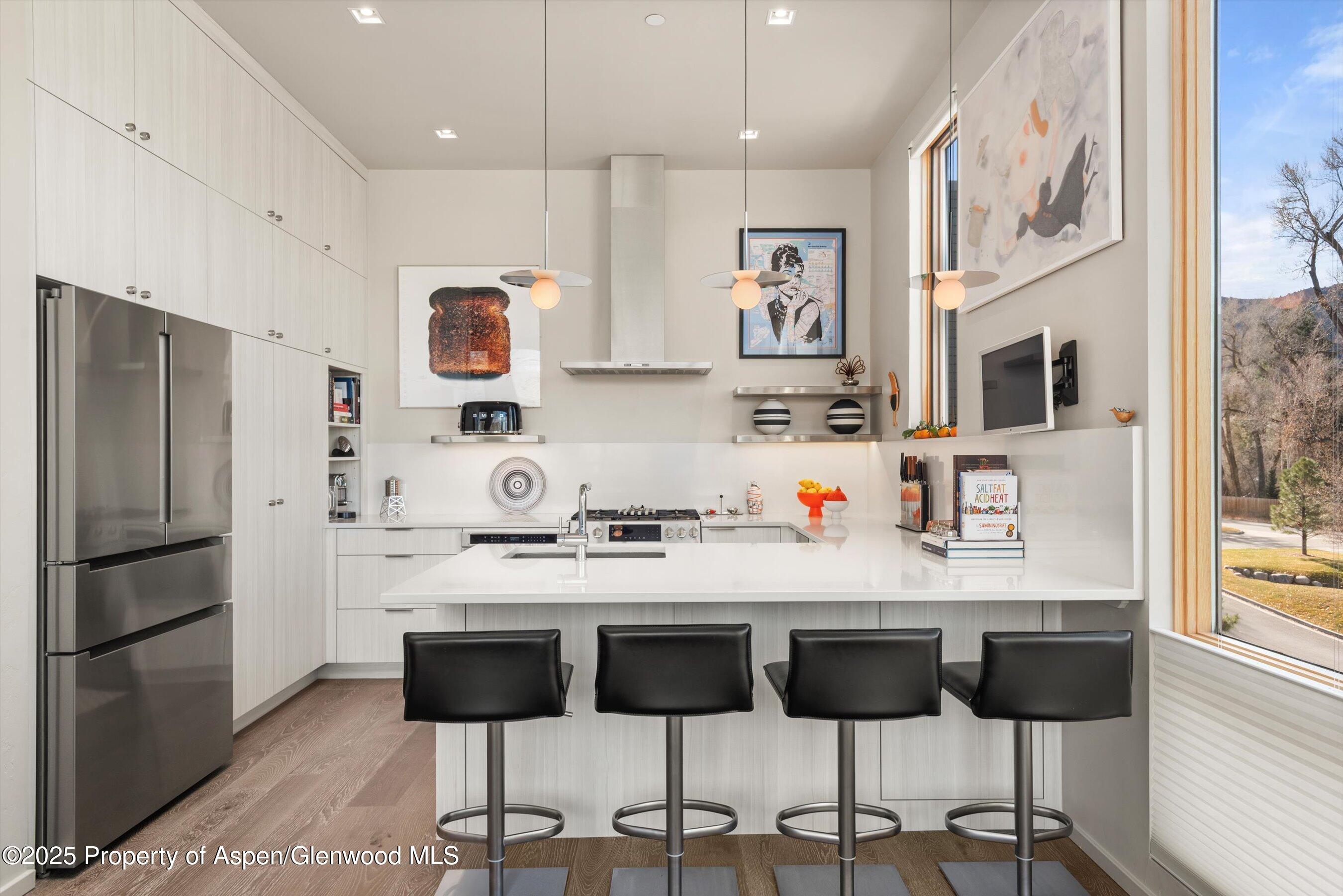 103 Willits Lane, Unit 204 Basalt, CO 81621 - Photo 8 of 24 a kitchen with stainless steel appliances granite countertop a refrigerator and a stove top oven