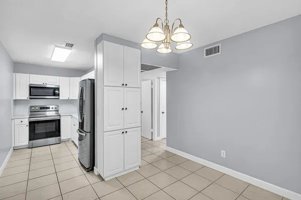 a kitchen with a sink stainless steel appliances and cabinets