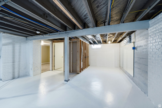 1925 South Main Street Bountiful, UT 84010 - Photo 23 of 48 Spacious basement area featuring a bright white floor and painted brick walls