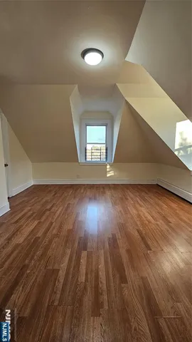 a view of room with wooden floor
