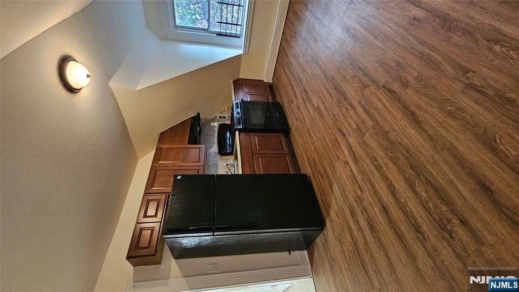 78 North Arlington Avenue, Unit 3 East Orange, NJ 07017 - Photo 3 of 13 a kitchen with stainless steel appliances wooden floor and a refrigerator
